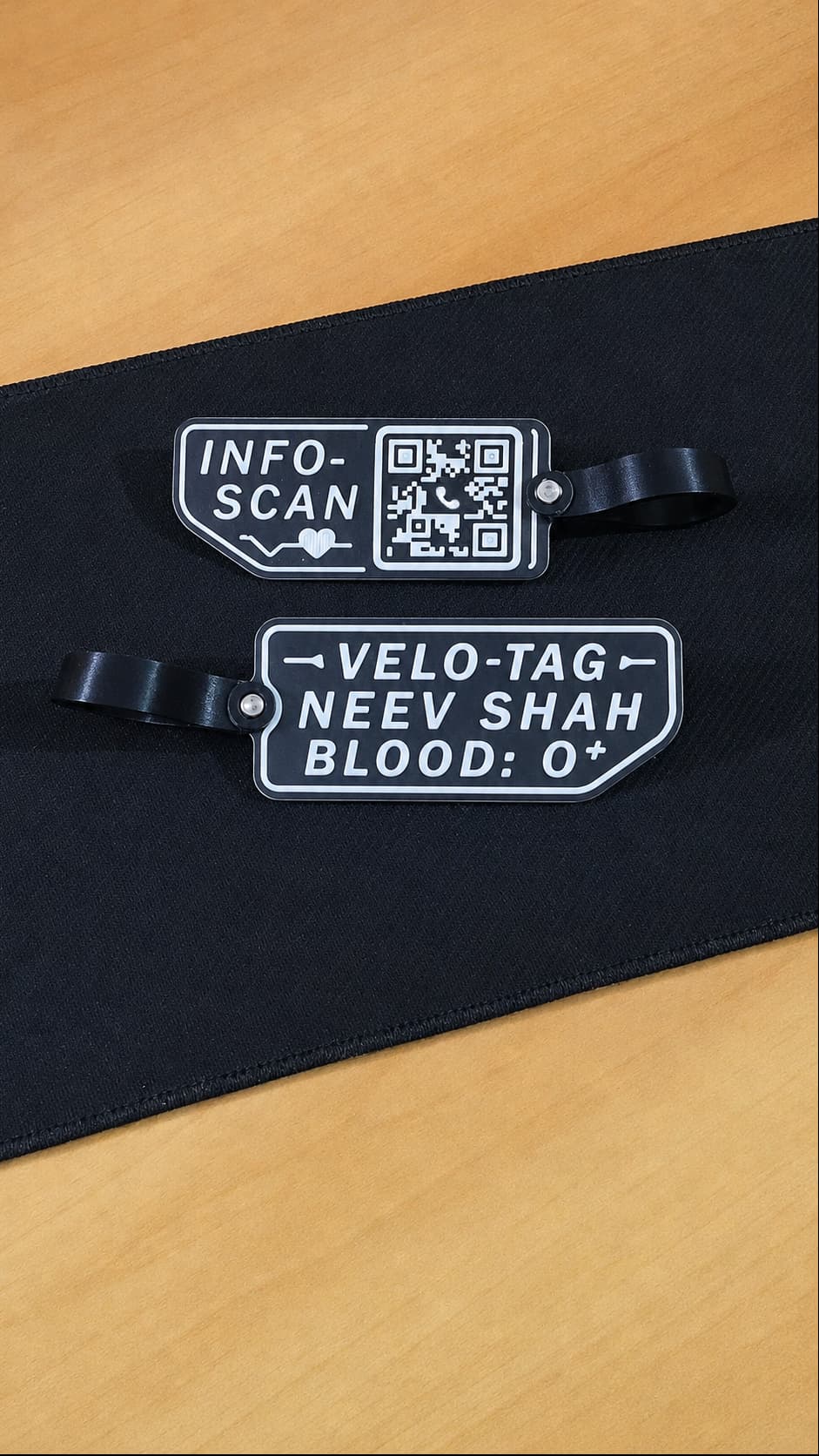 Front and back views of a Pedalink tag, showing the QR scan side and rider-information side.